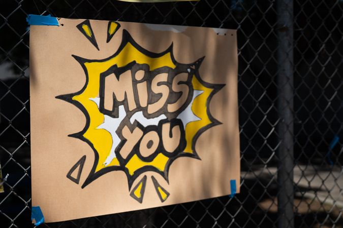 Close up shot of handmade sign with the words “Miss you”