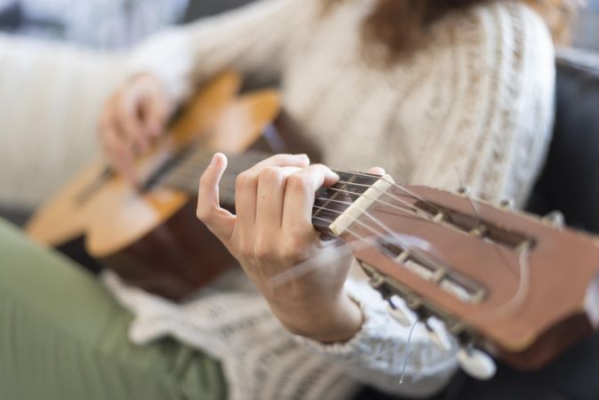 Female hand on fretboard of guitar