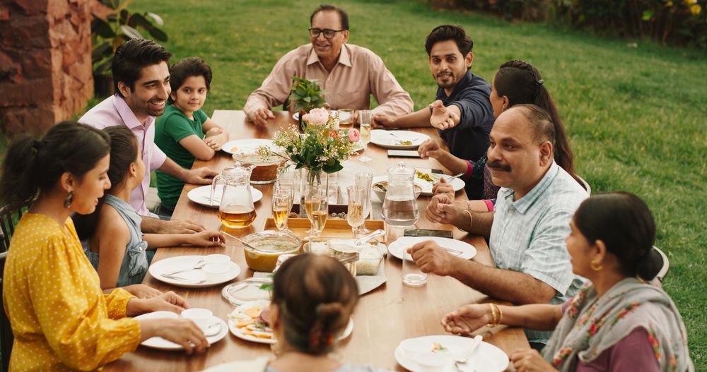 Indian Family Gathering Portrait: Family and Friends Celebrating Outside at Home.
