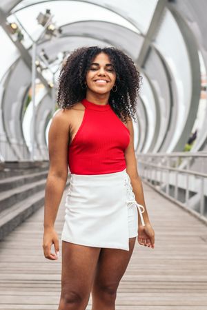 Portrait of a woman with afro hair enjoying in summer in the city