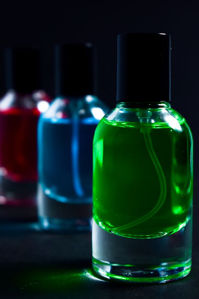 Different colored glass bottles in dark studio
