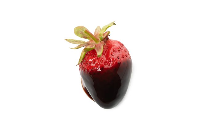 Chocolate fondue. Strawberry in chocolate sauce isolated on plain background
