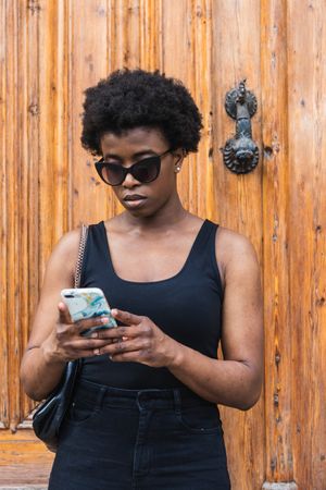 Black woman chatting on smartphone