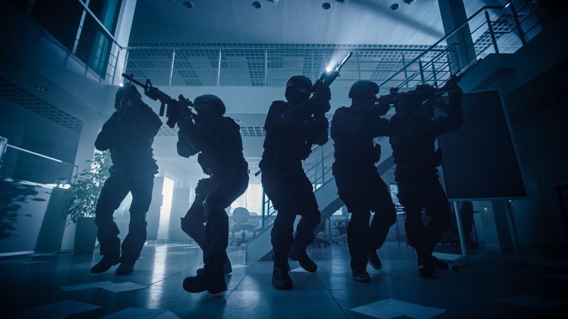 Masked Squad of Armed SWAT Police  Soldiers with Rifles and Flashlights Surveil and Cover Surroundings.