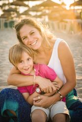 Happy mother with playful son on beach