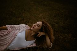 Woman sleeping on grass in countryside