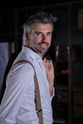 Mature man in formal outfit in wardrobe