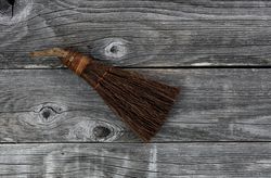 Vintage handbroom on old wooden floor