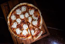 Freshly baked Italian pizza on wooden board