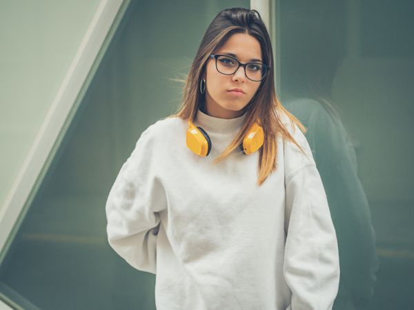 Trendy young woman with headphones and smartphone