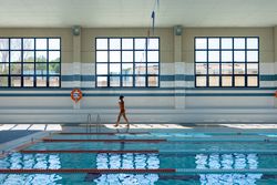 Black young woman walking by the curb at the swimming pool