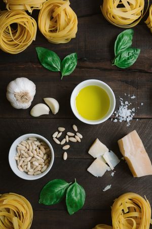 Ingredients for pesto pasta arranged at table
