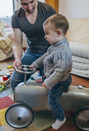 Father teaching his son how to drive small racing car