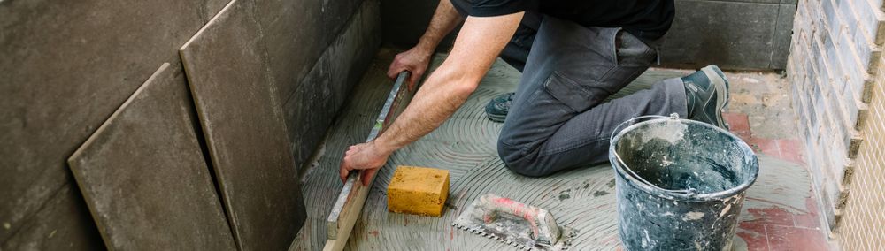 Bricklayer checking floor with a level