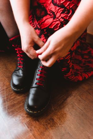 Woman in dress lacing boots