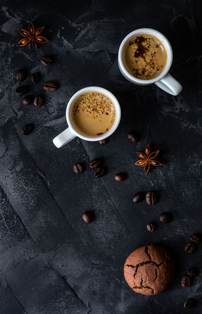 Top view of two espressos and cookie