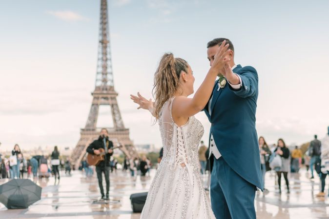 Happy newlyweds in wedding clothing dancing together