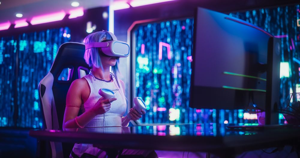 Young Cosplay Female Exploring VR Metaverse Online While Sitting Behind a Desk with Computer