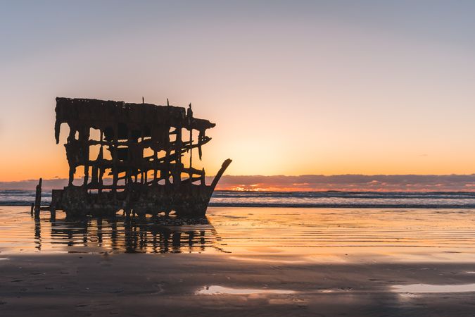 Frame of ship on seashore during sunset