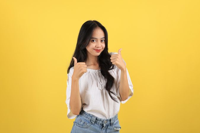 Young Asian Teenager  Women Happy  Smiling to the Camera and Give Two Thumbs Up