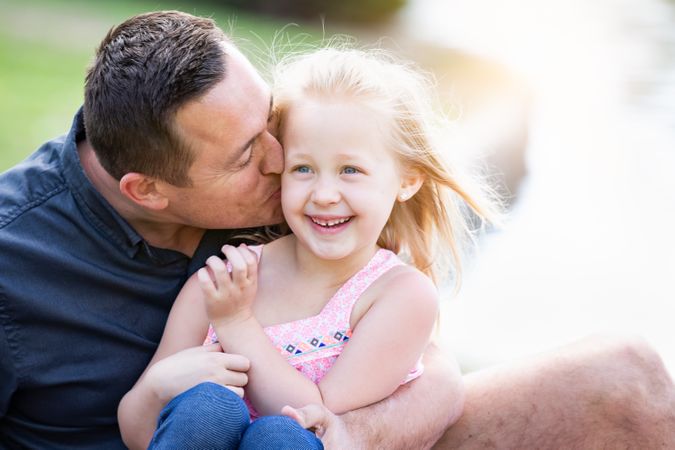 White Father and Daughter Having Fun At The Park
