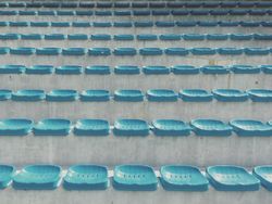 Blue plastic seats on large concrete stairs 41rQ7b