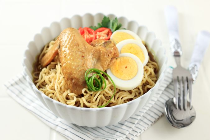 Indonesian Instant Noodles with Sliced Boiled Egg, Tomato, and Chicken WIngs