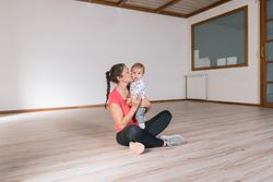 Woman holding baby in gym