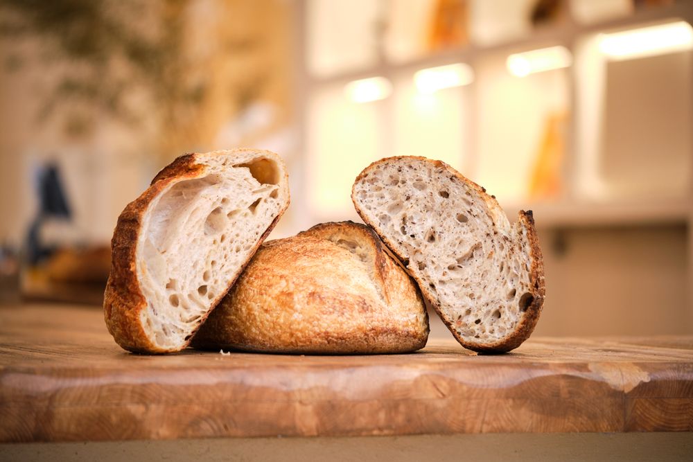 Still life photo of rustic bread on a wooden background with nat