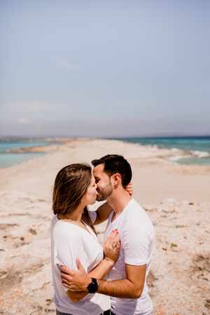Loving couple embracing on coastline