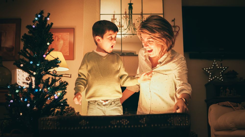 Mother and son opening magic chest on Christmas Day
