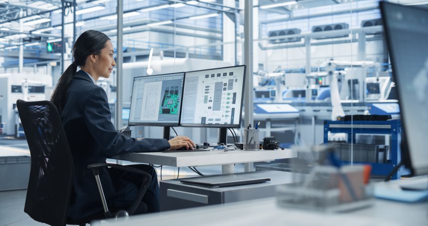 Asian Industrial Engineer Doing Creative Work on Computer in Office. Intelligent Female Creating an Innovative Motherboard with Powerful Microchips for Artificial Intelligence Systems