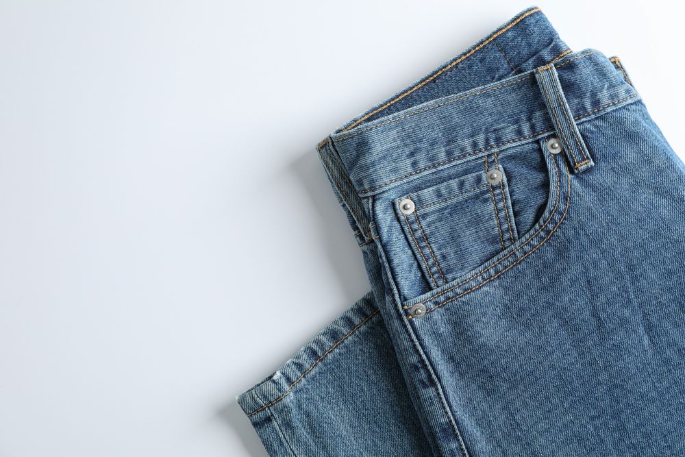Jeans on light background, space for text