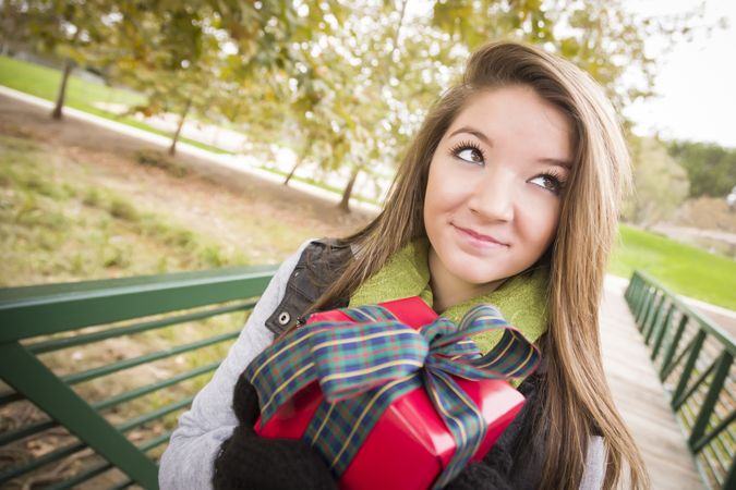 Female with Wrapped Gift and Bow Outdoors