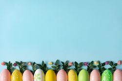 Pastel eggs row on baby blue background