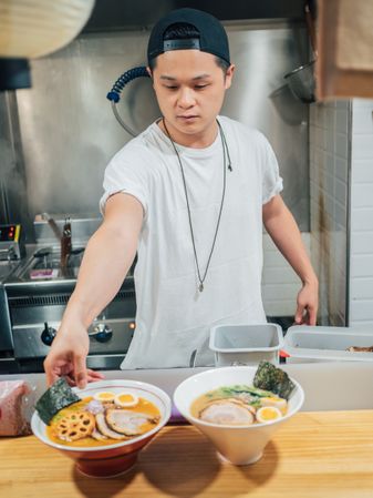 Asian chef with served bowls of ramen
