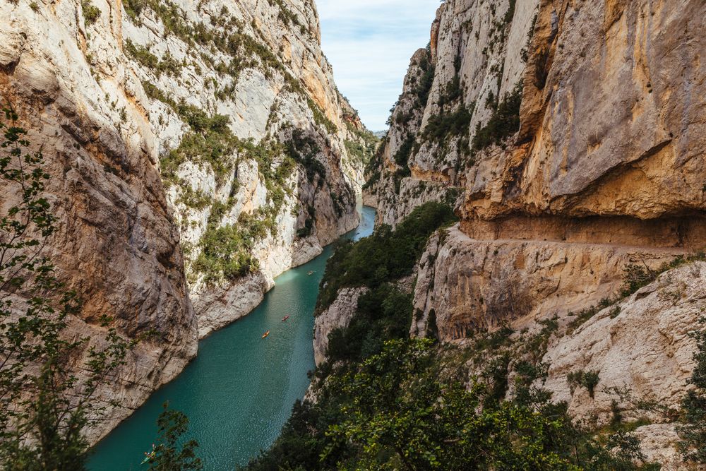 People crossing a river by kayak