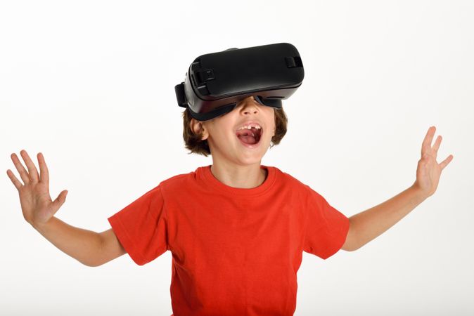 Excited girl in VR glasses and gesturing with arms opened