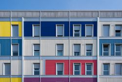 Facade of modern multicolored building with narrow windows