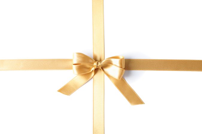 Golden ribbon with bow isolated on plain background. Gift concept