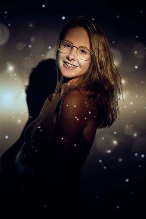 Cheerful young woman under sparks