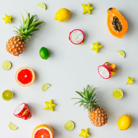 Tropical fruit, pineapple, papaya, dragonfruit on light background