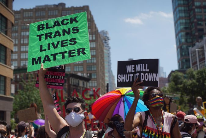 Person holding banner with text  "Black Trans Lives Matter" during Queer Liberation March in New York City