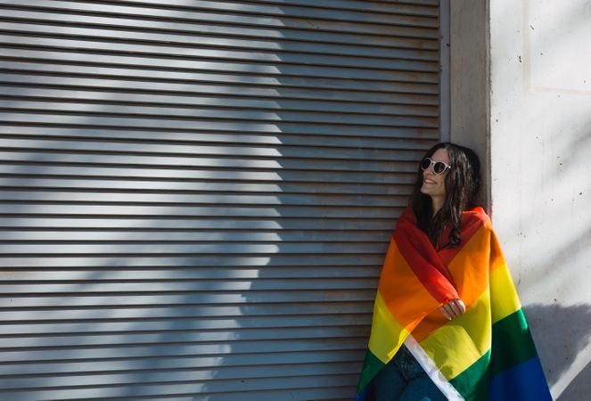 Woman posing happily with the LGBT flag