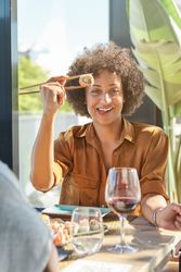 Smiling Black woman having dinner