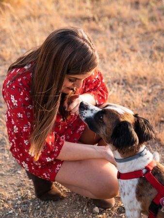 Woman with small friendly dog outdoors