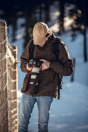 Man between winter forest in sunny day