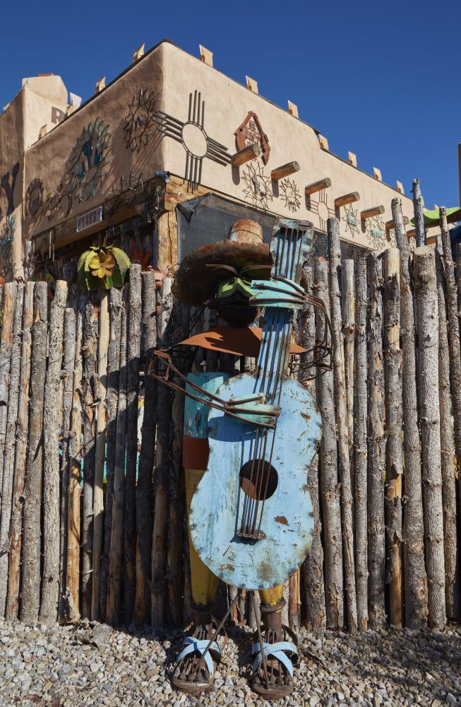 A painted metal-art figure resembling a mariachi band musician