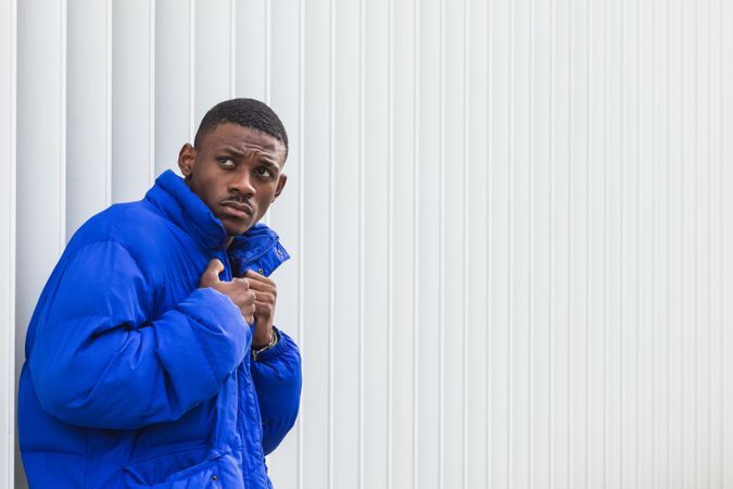 Black stylish man in warm jacket on street