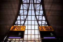 Signs at an airport with contemporary architecture